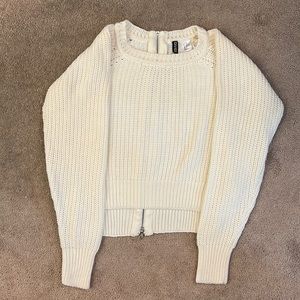 Cropped knitted sweater with zipper back.